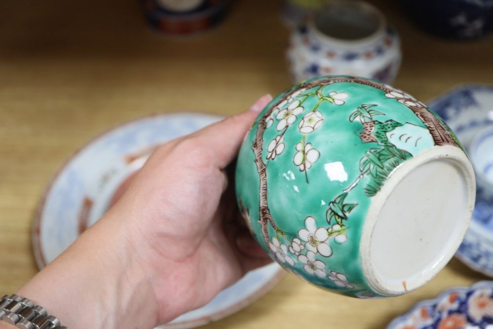A collection of mixed Chinese and Japanese porcelain and pottery including a Nanking Cargo blue and white tea bowl, a 19th century